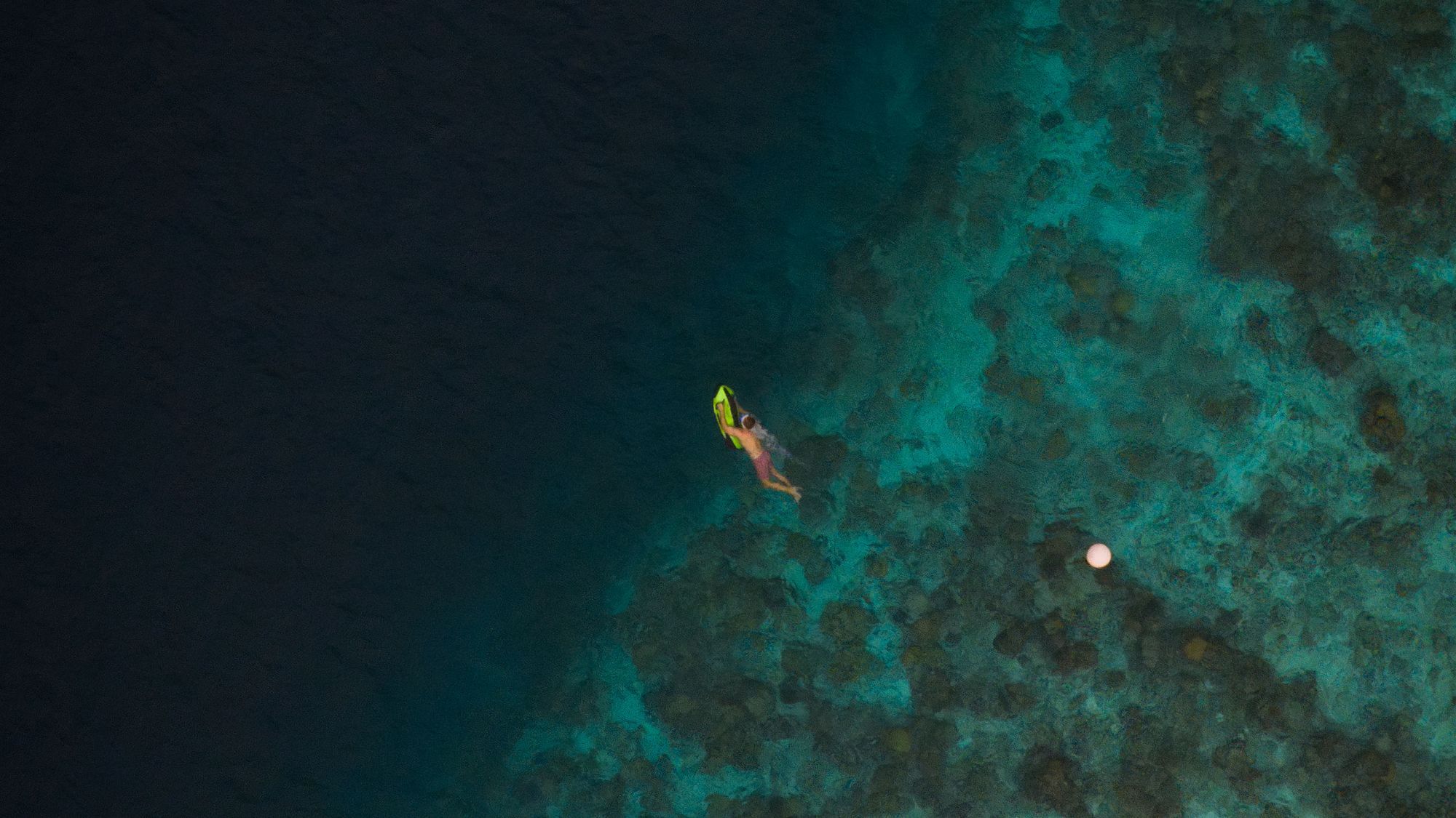 Seabob rider crossing the reef edge, seen from above