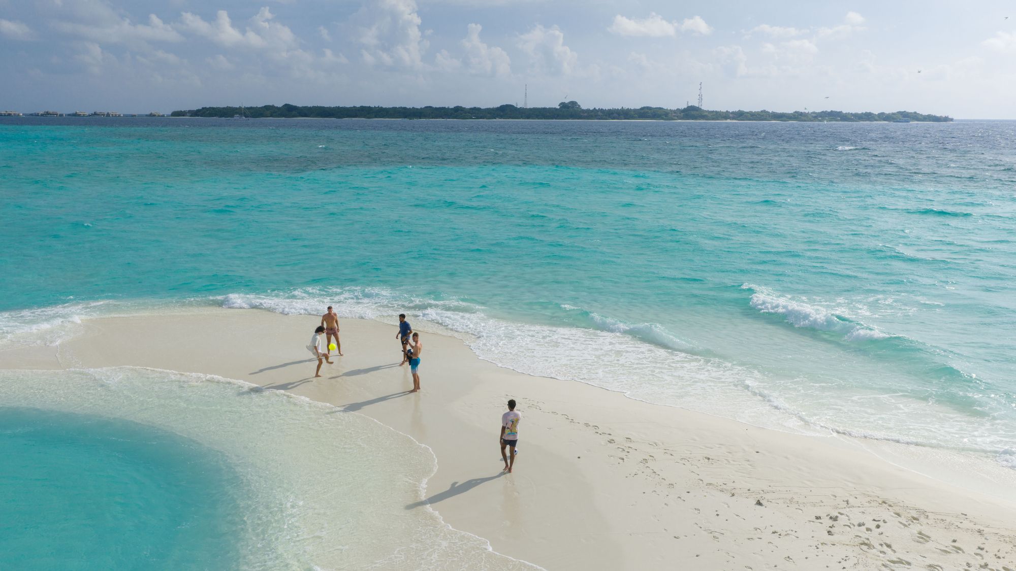 Guests walking a private sandbank